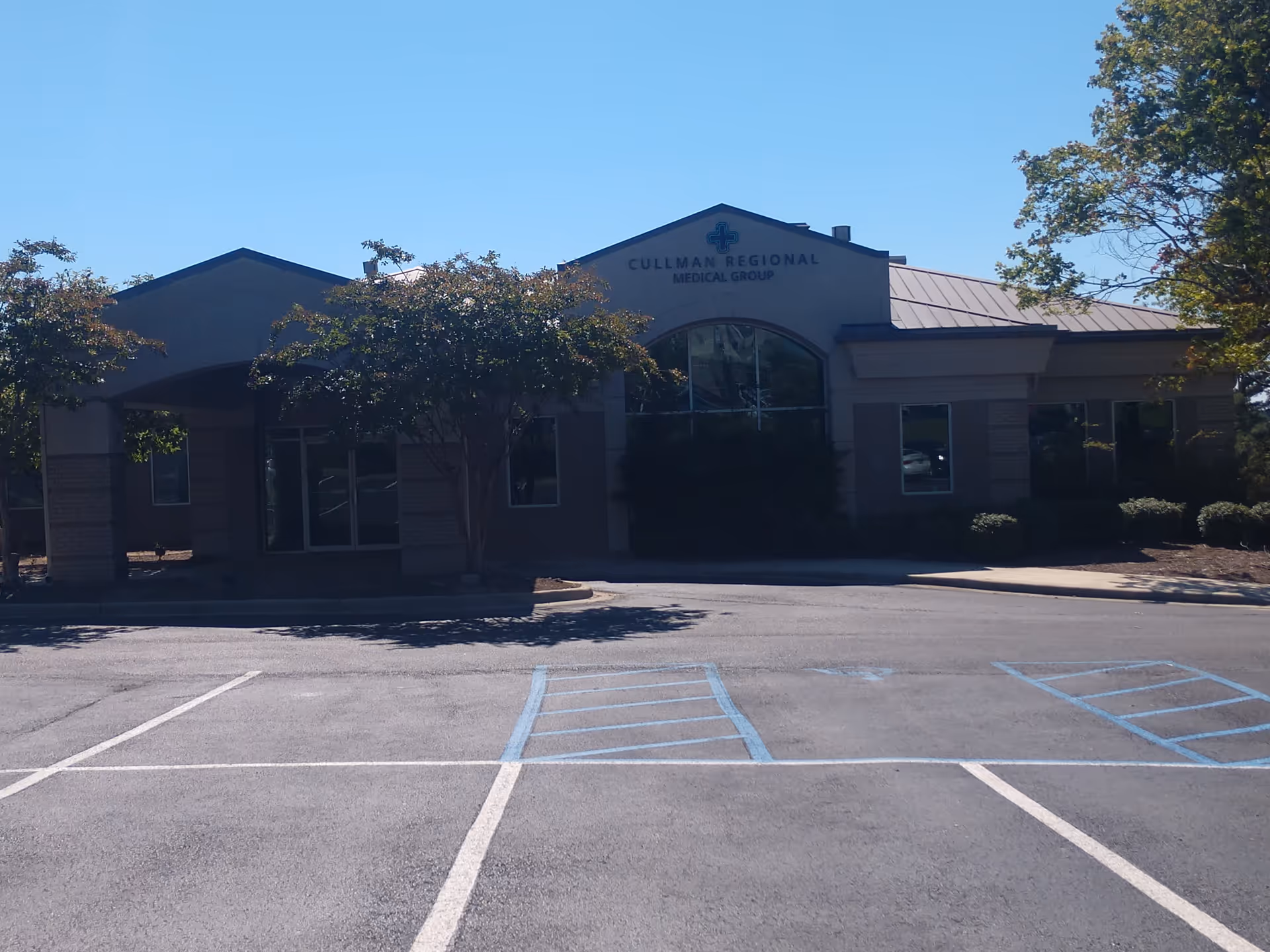 Exterior view of Cullman Regional Medical Group building with entrance and parking lot