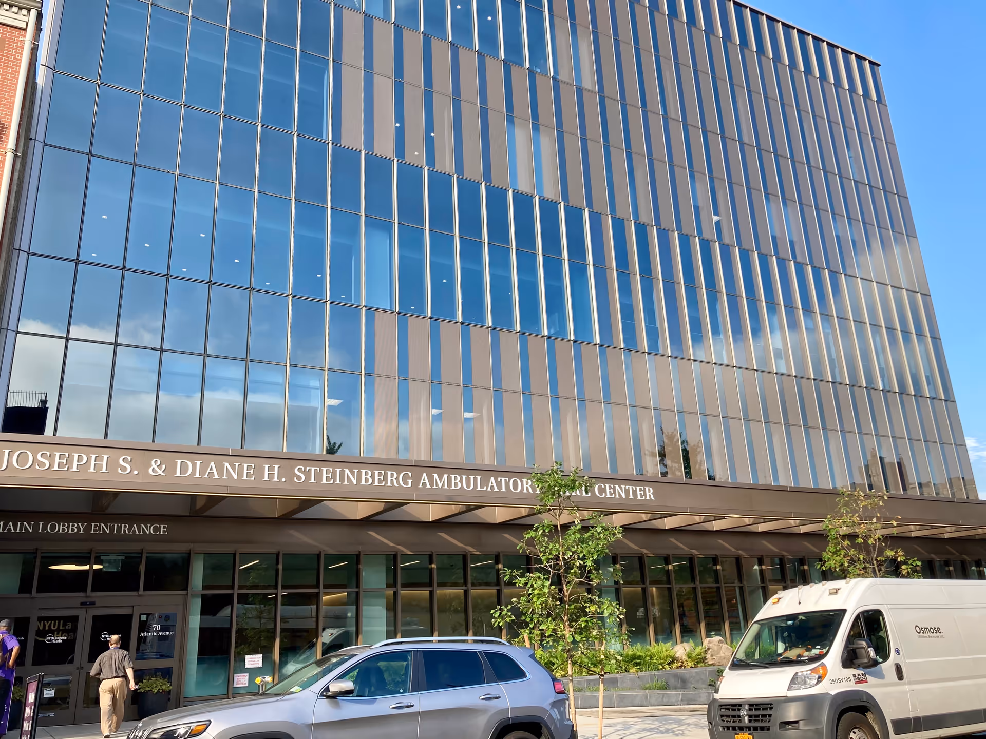 The Steinberg Ambulatory Care Center Cobble Hill exterior shows a glass facade with entrance and vehicles.