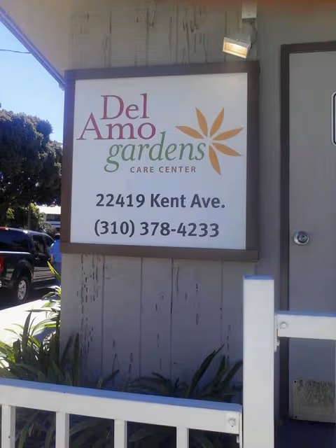 Exterior view of Del Amo Gardens Care Center sign with address and phone.