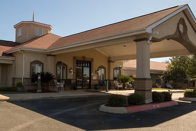 Exterior view of Brookdale Medical Center Kingsley front entrance with a covered drive and seating.