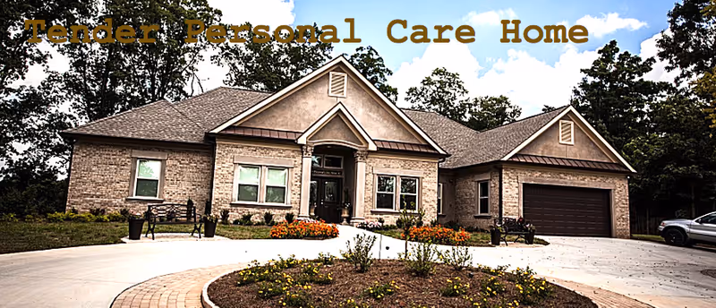 Front view of a brick senior care home with a circular driveway and landscaped entrance.