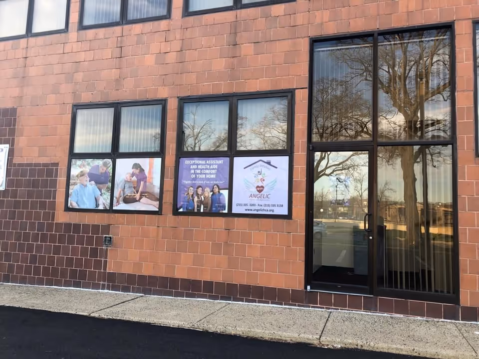 Brick exterior of Angelic Home Care Agency with large glass entrance doors and windows.