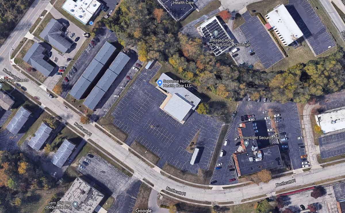 Aerial view of Supreme Home Health Care LLC facility with a large parking lot.