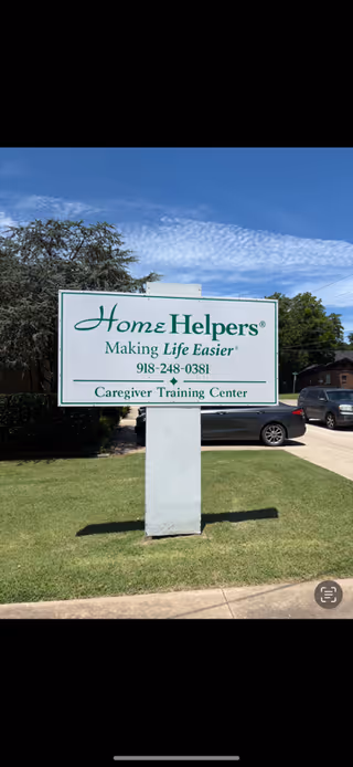 Outdoor sign reads Home Helpers Making Life Easier and Caregiver Training Center, McAlester, OK.