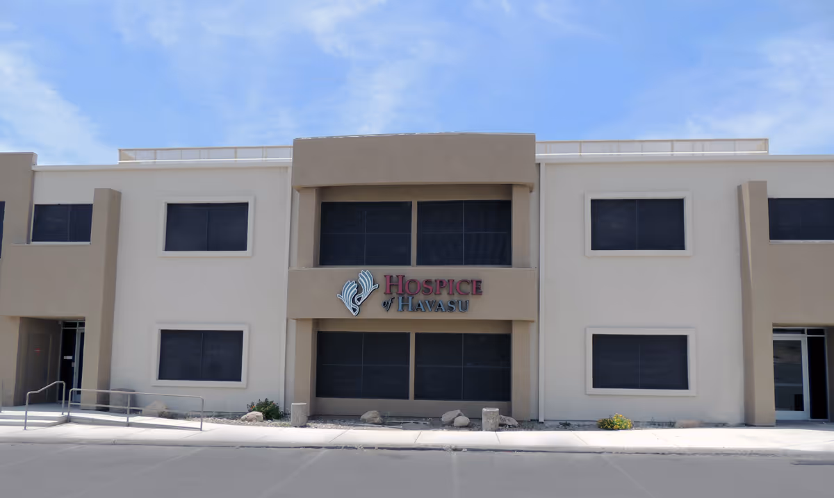 Two-story beige facility with Hospice of Havasu signage on the front.
