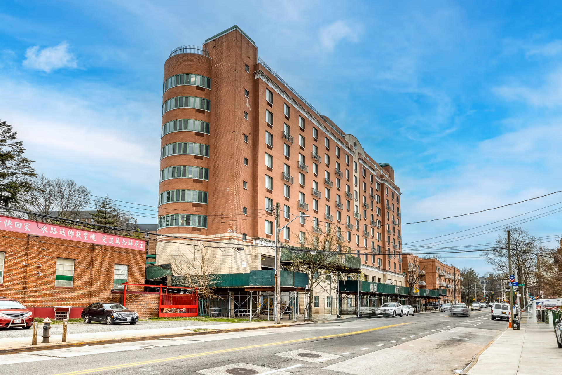 A tall brick Union Plaza Care Center sits along a city street with scaffolding.