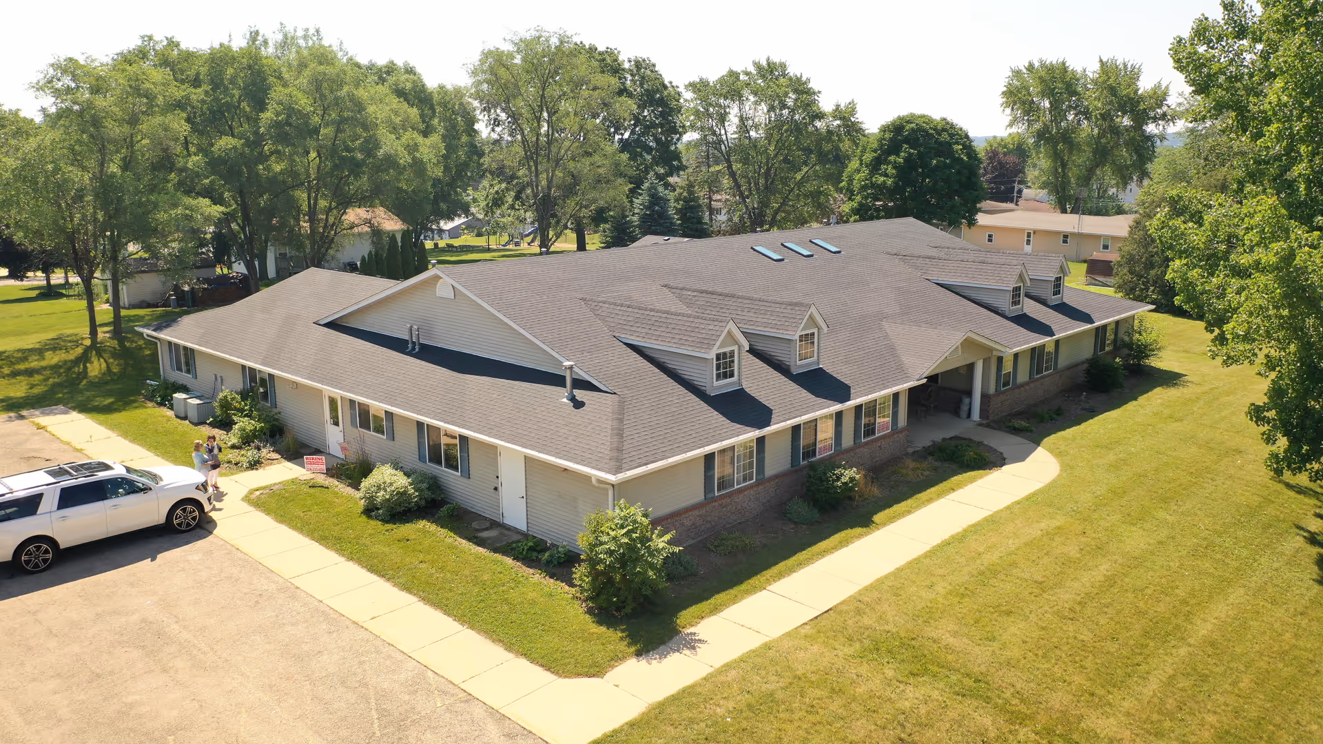 A single-story Shepherd Premier Senior Living building with a gray roof and surrounding lawn.