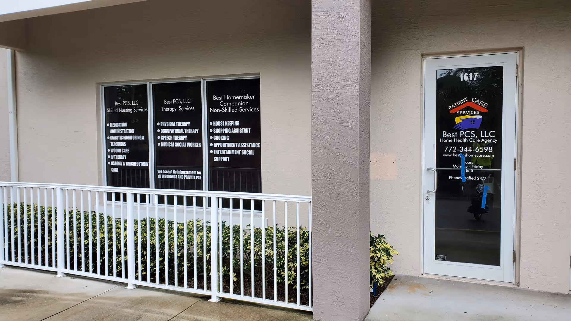 Exterior view of Best PCS, LLC facility with a glass door and window signage.