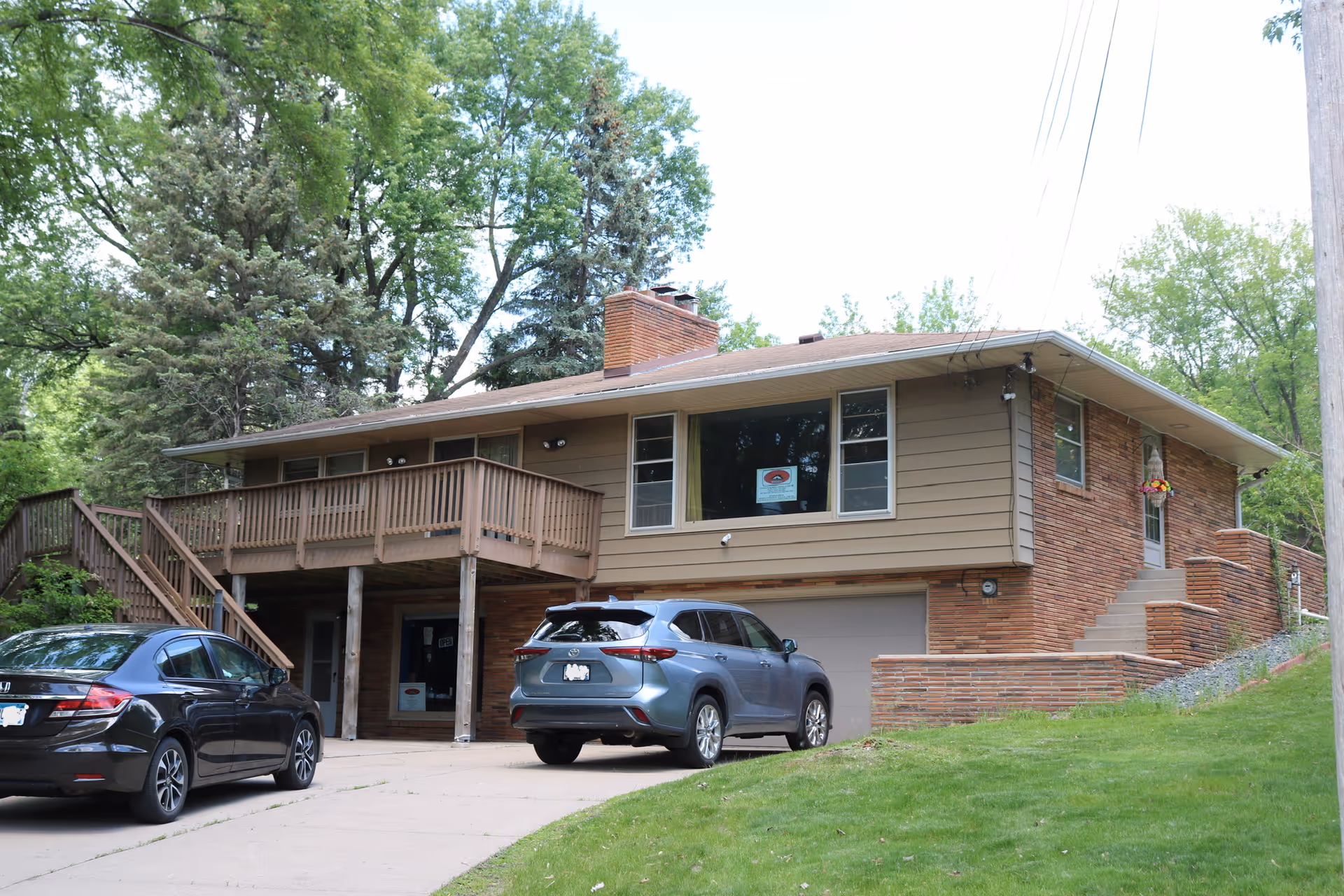 Exterior view of Bhutnese Home Health Care Services building with cars parked in driveway.