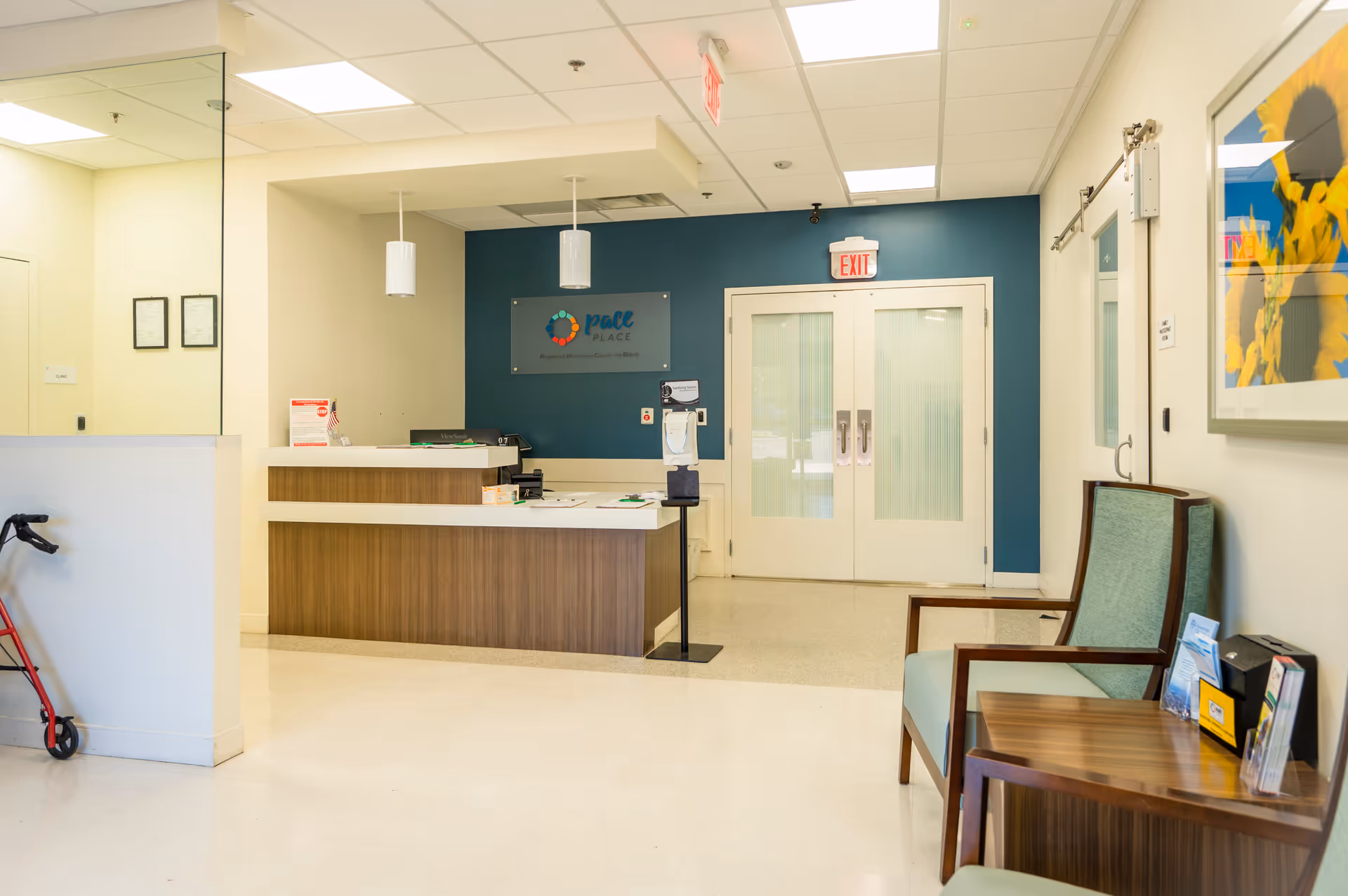 Lobby reception area with wood-front desk and teal accent wall.