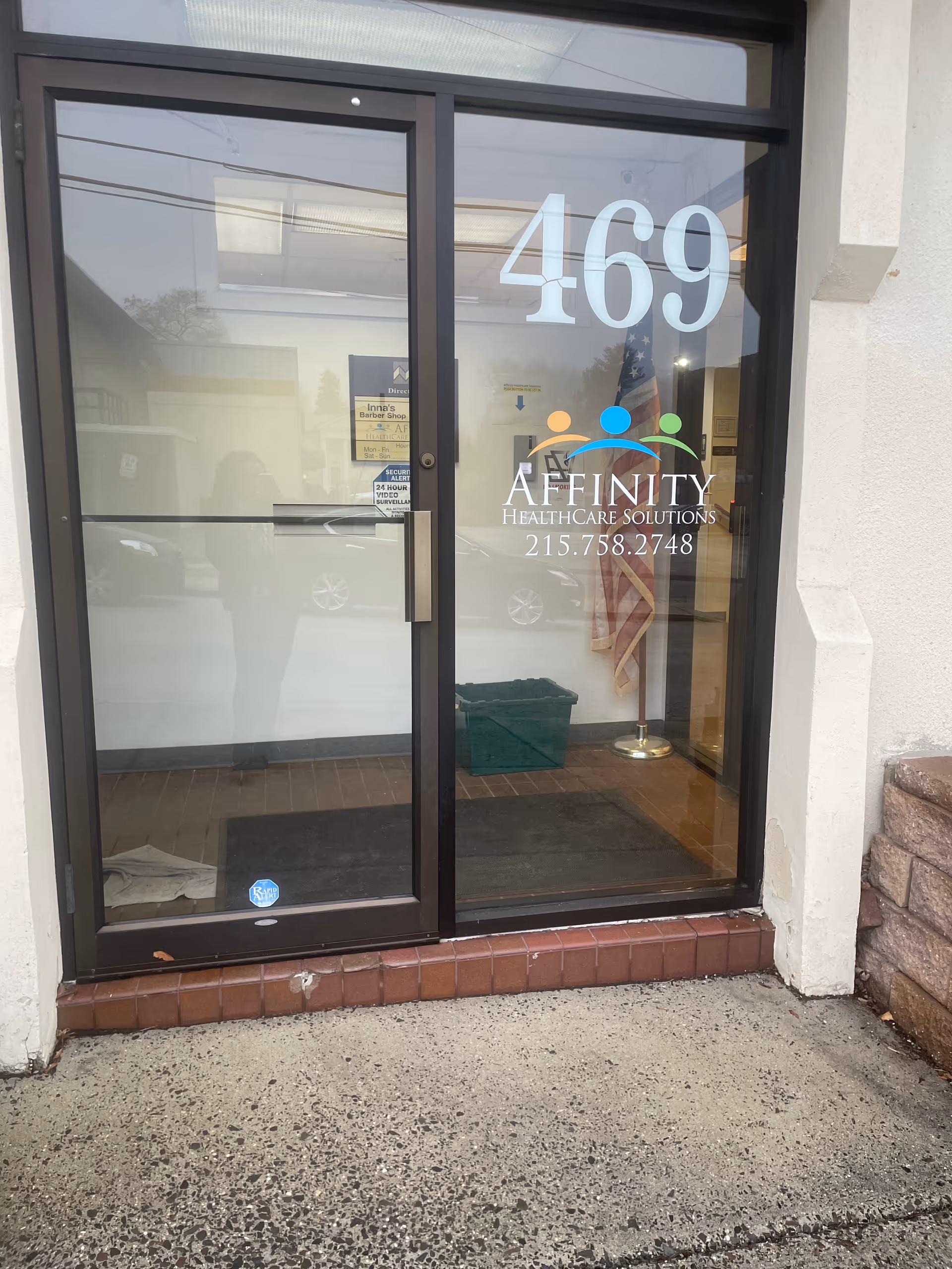 Glass entrance door displaying Affinity HealthCare Solutions logo and 469