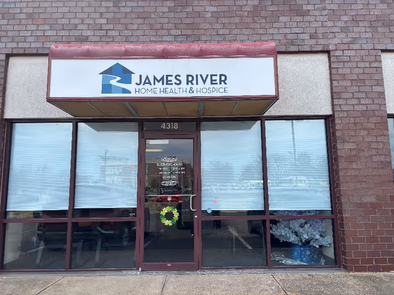 Front of brick building with glass entrance and James River Home Health and Hospice sign