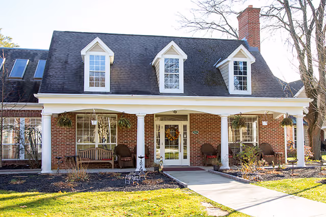 Exterior view of Brookdale Wooster showing brick building with porch and seating