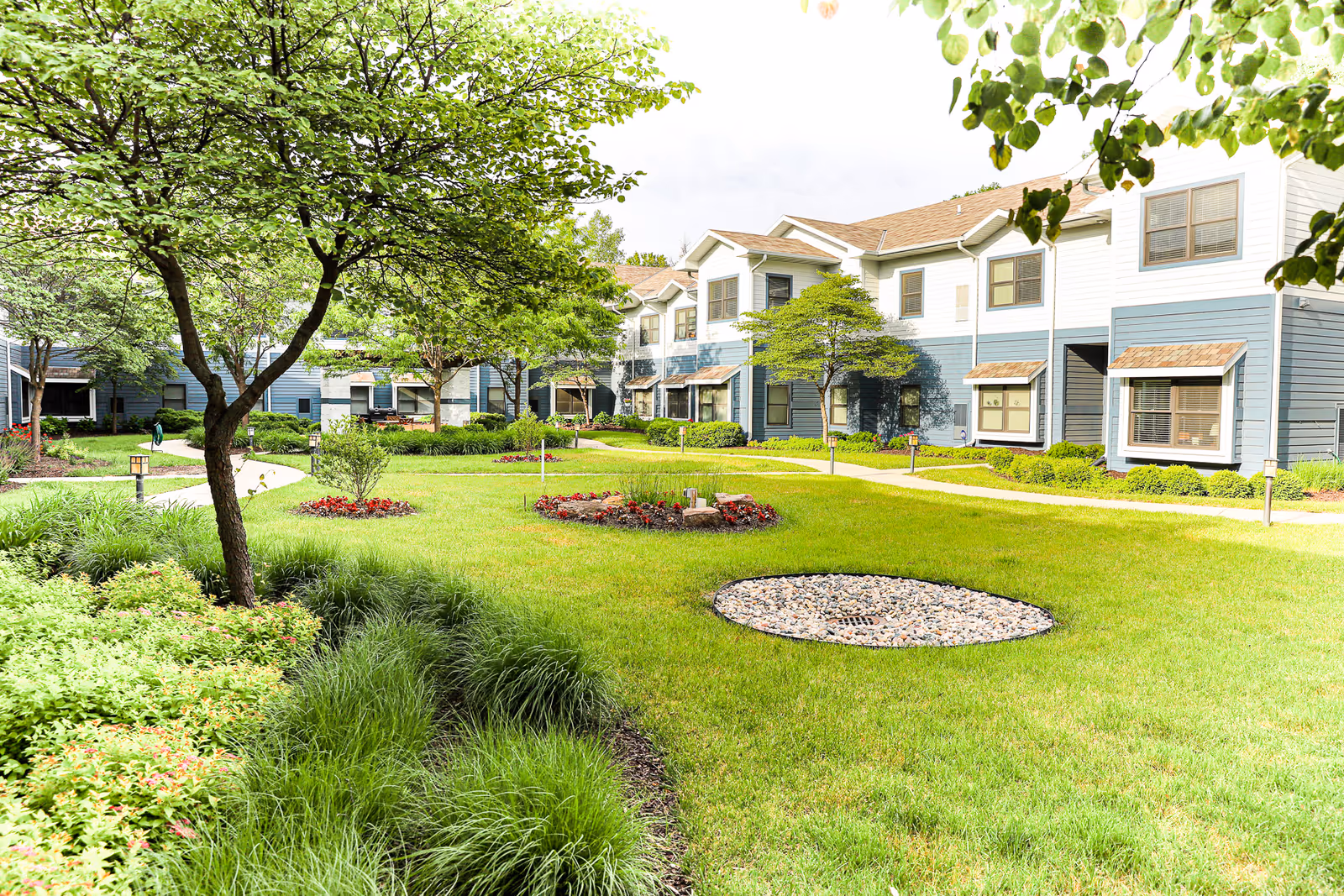 Exterior view of Heritage Ridge Retirement Community with green lawn and apartment buildings.