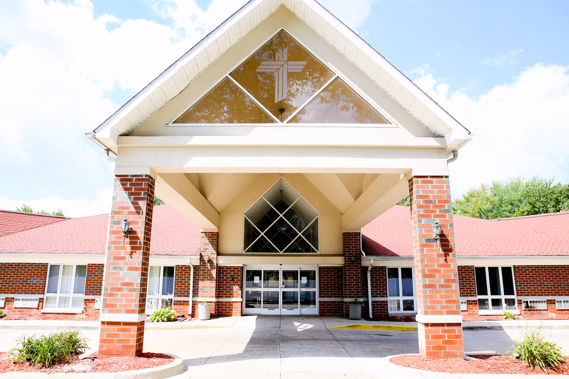 Front view of Fountain Bleu Health and Rehab Center with brick facade and glass doors.