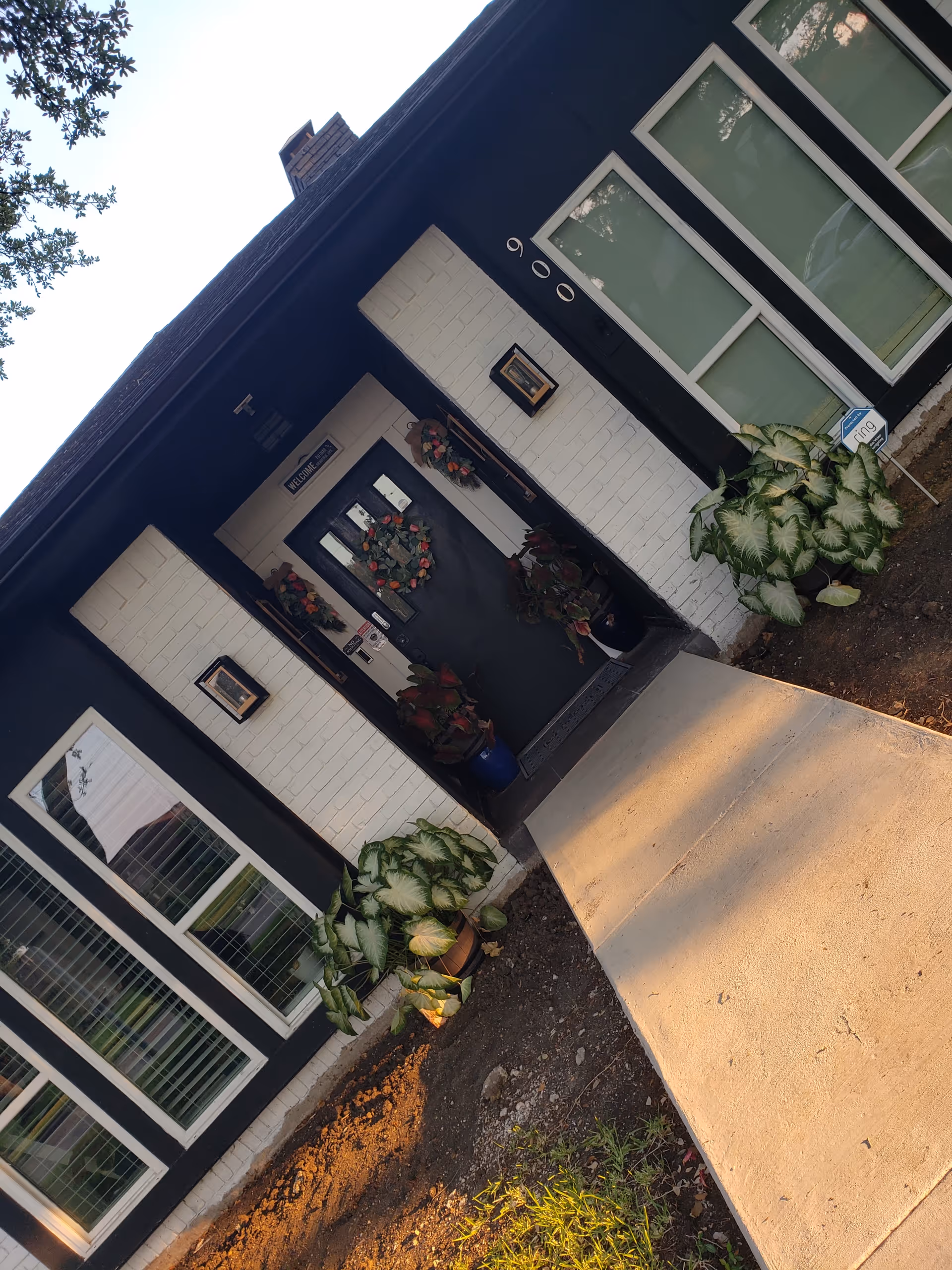 Front entrance of Integrity Residential Care with wreaths, plants, and a curved walkway.