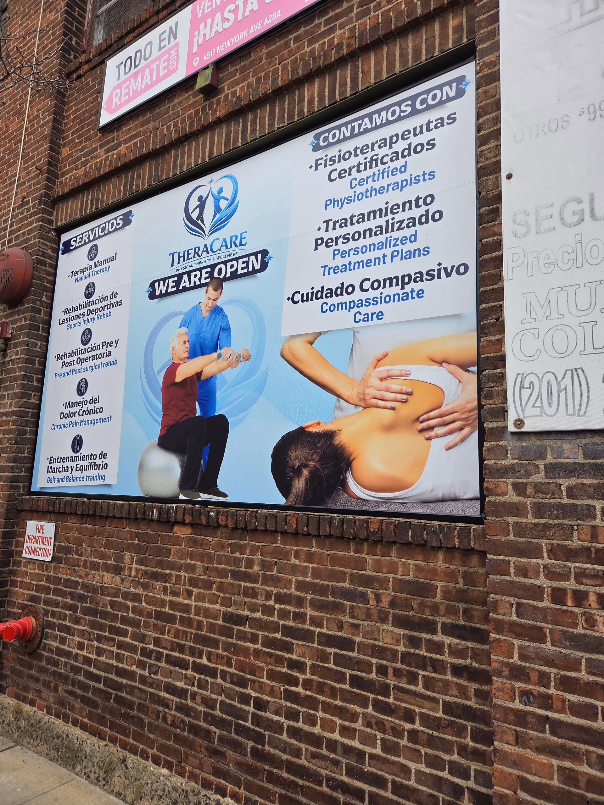 Exterior brick wall with a large Theracare sign and medical posters.