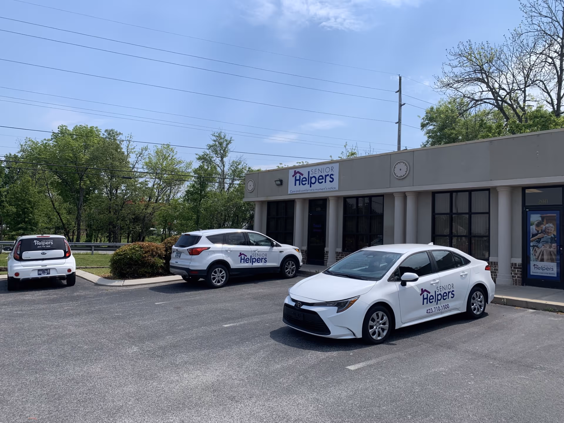 Exterior front of Senior Helpers of Chattanooga building with three parked company vehicles.