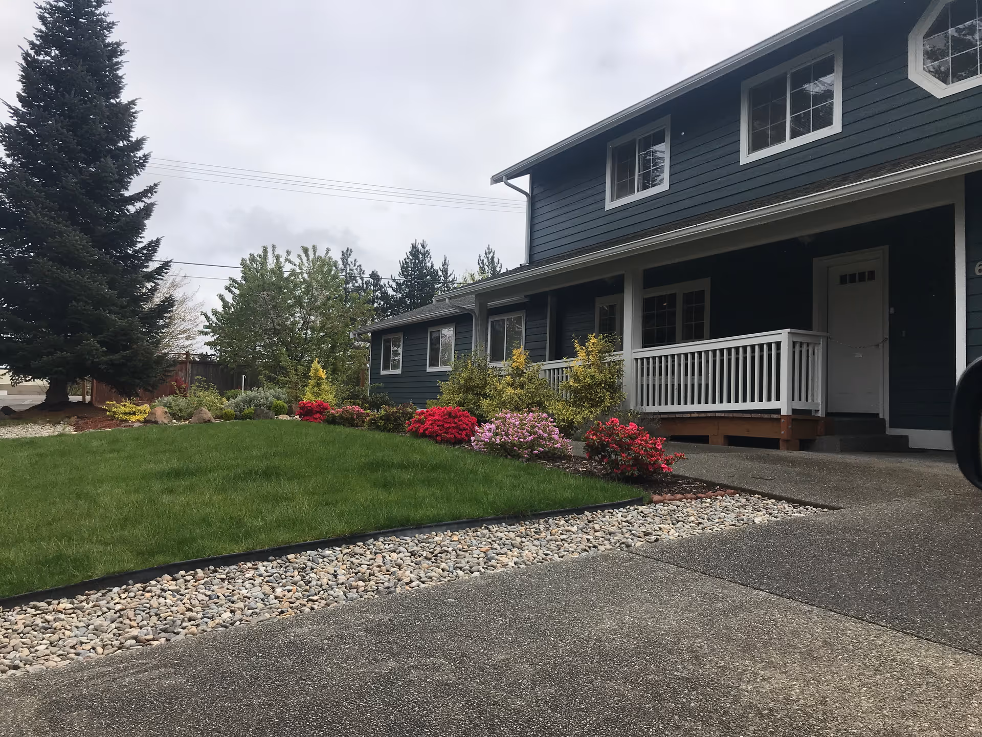 Blue Haven senior living building exterior with landscaped front yard and porch.