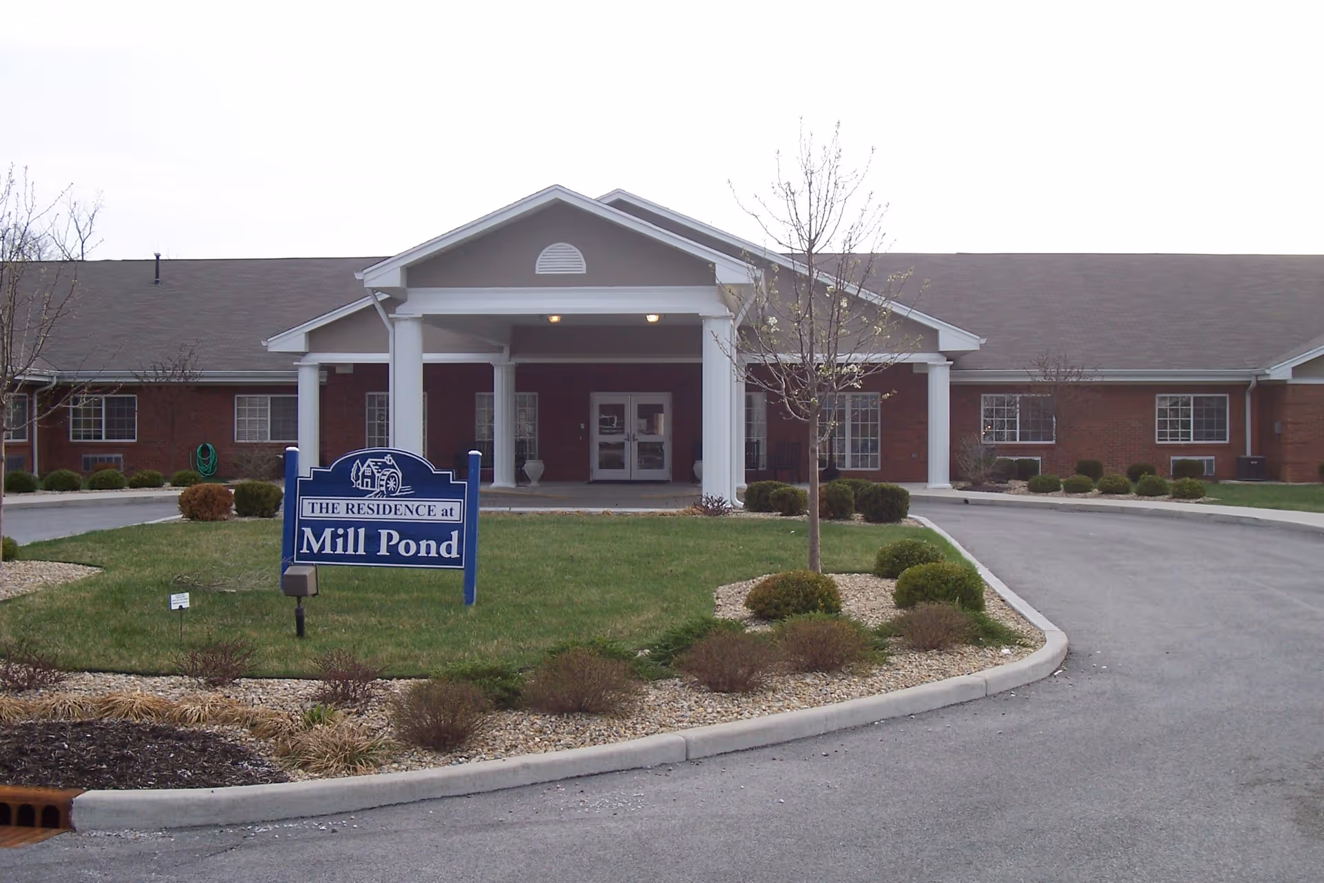 Front view of Mill Pond Health Campus, a brick building with a covered entrance and sign.