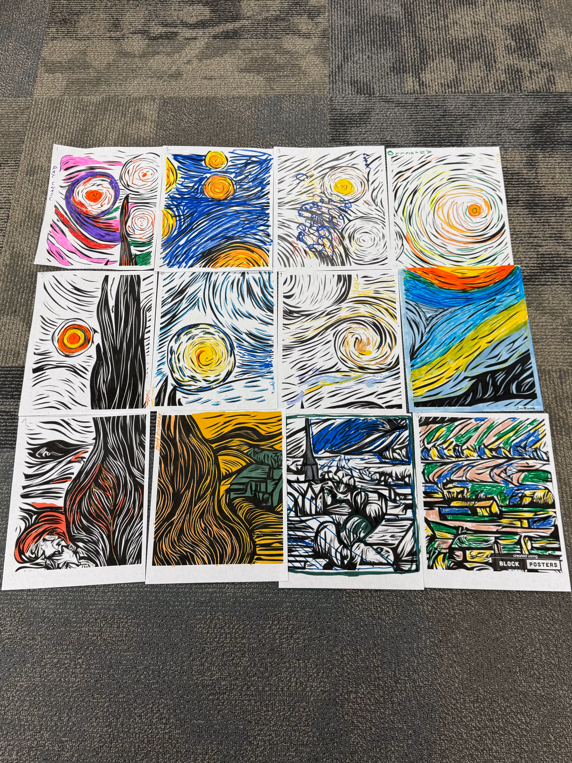 Colorful art prints arranged on a patterned carpet indoors.
