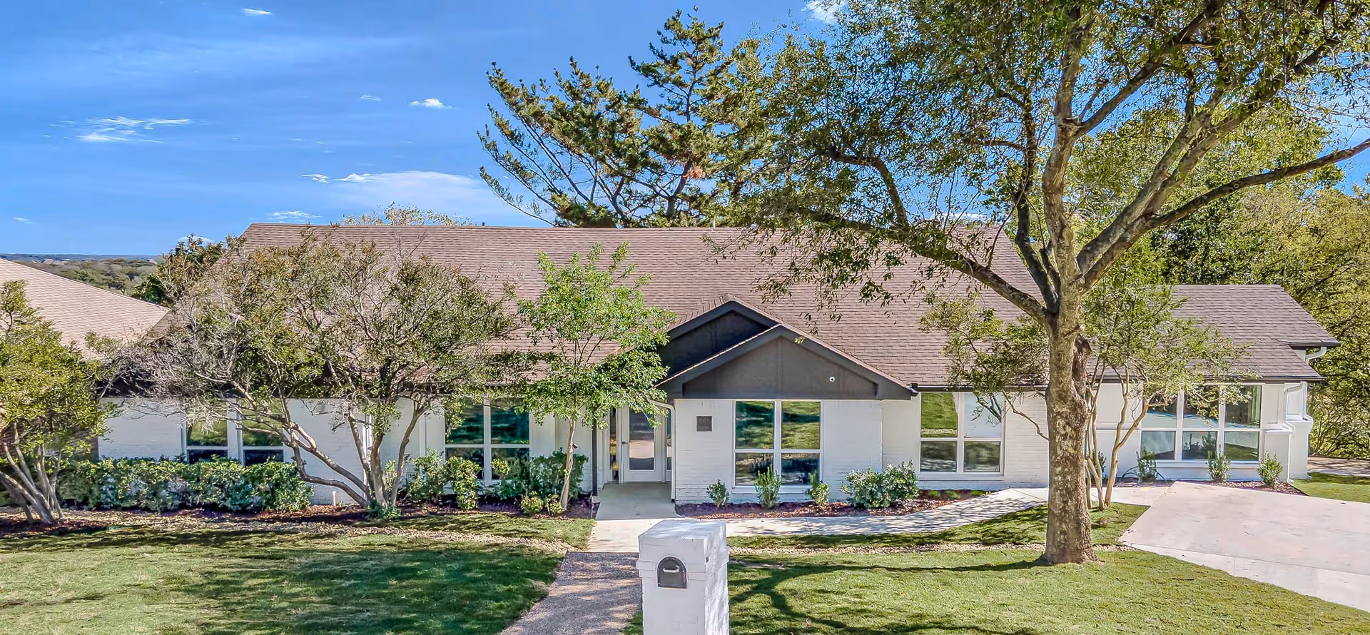 Front view of Silver Leaf Assisted Living & Memory Care building with trees.