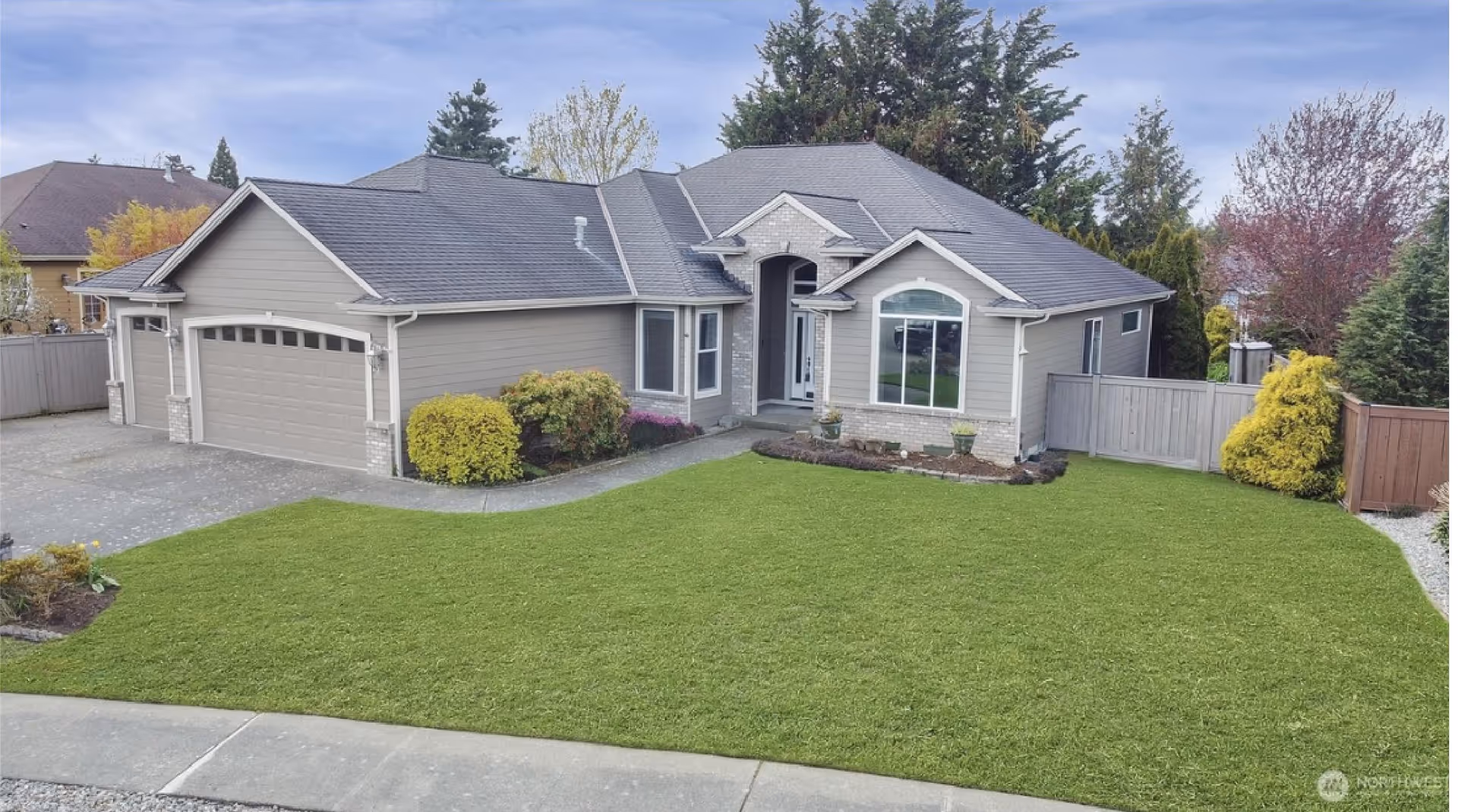 Front exterior of Buckley Care Adult Family Home, showing a manicured lawn and driveway.