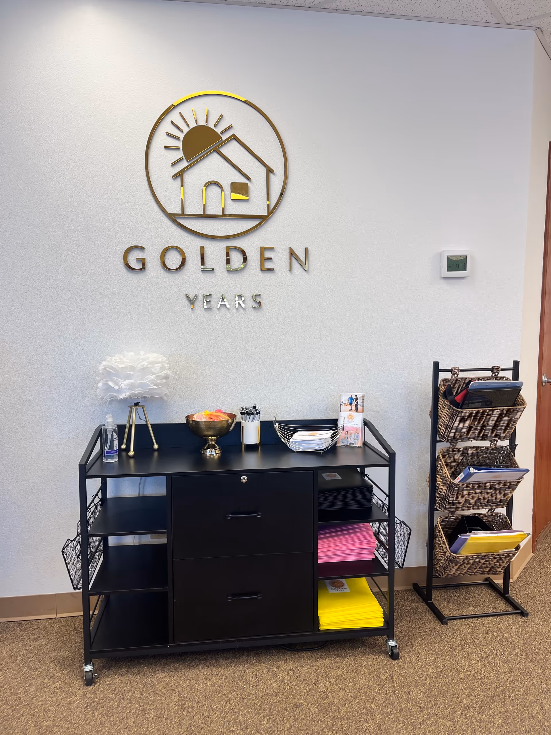 Interior reception area with Golden Years sign, a black service cart, and brochure rack.