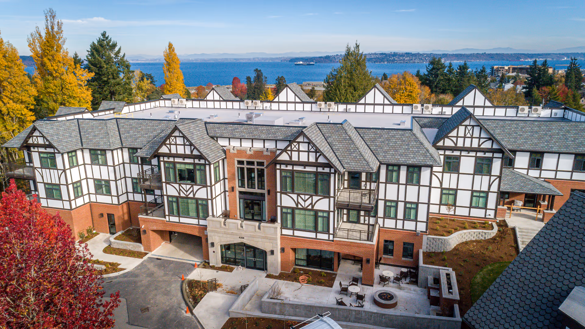 Aerial view of Franke Tobey Jones senior living campus with Tudor-style exterior and autumn trees.
