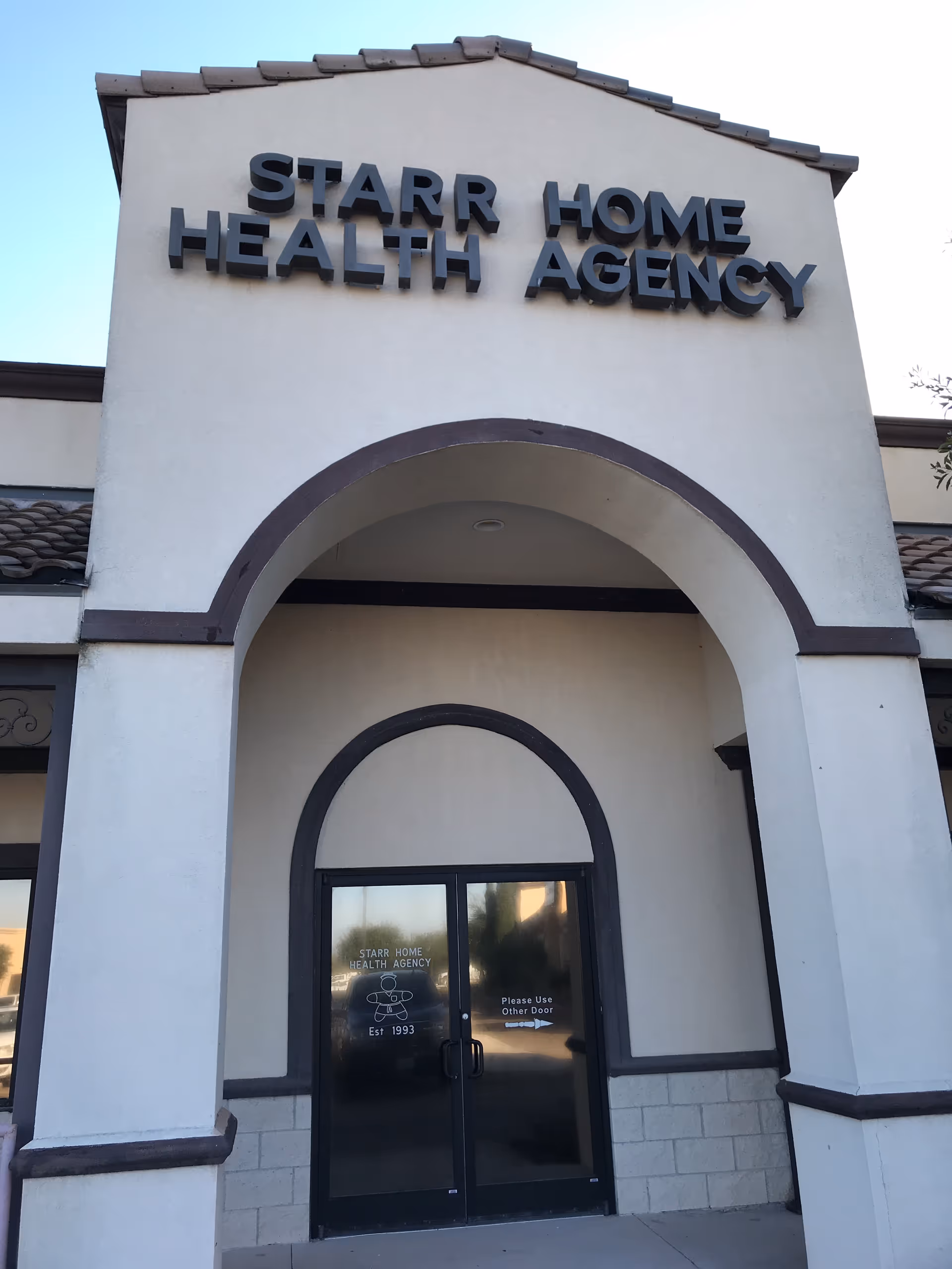Front facade of Starr Home Health Agency with arched entrance and double doors.