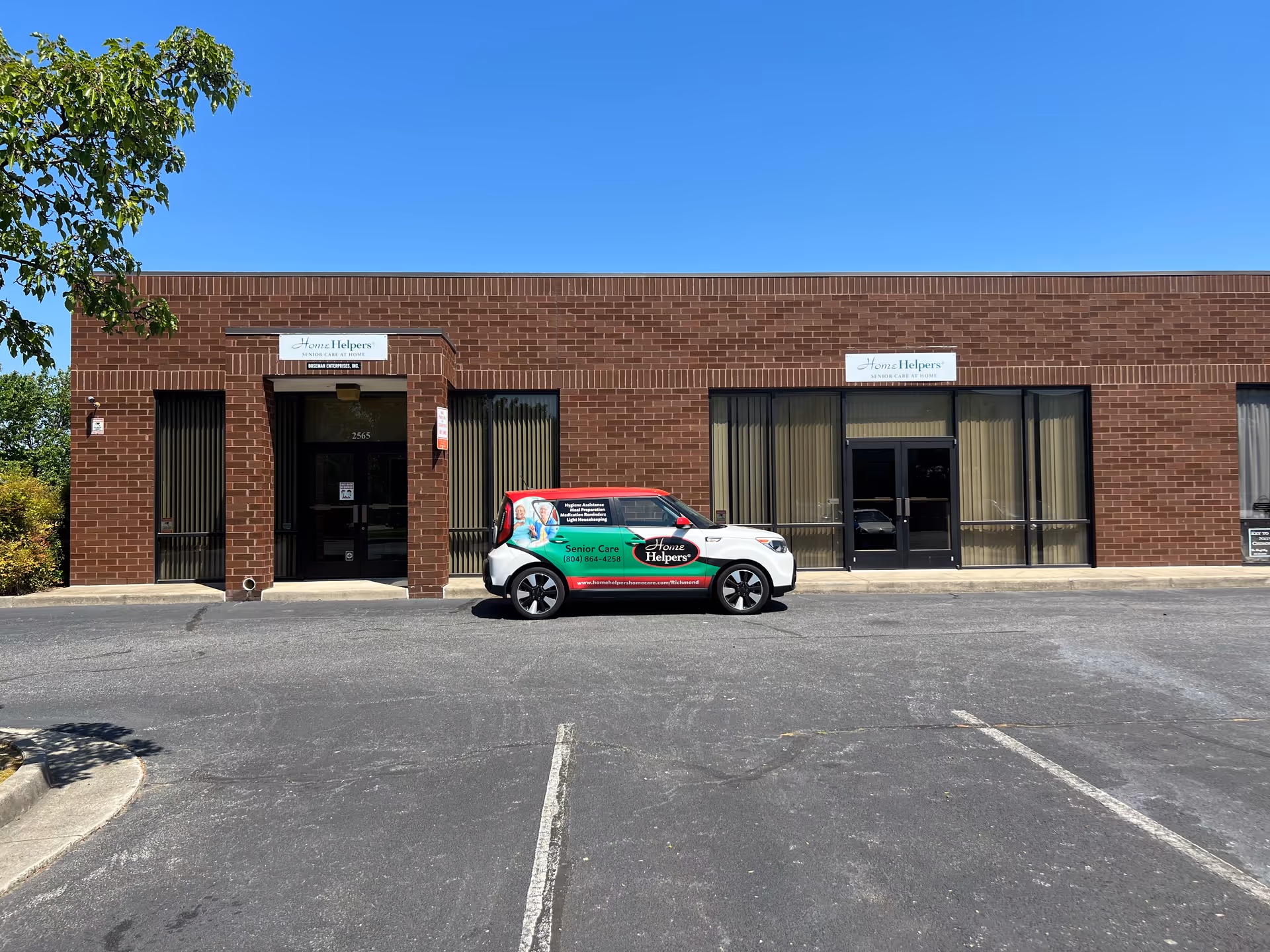Brick storefront with Home Helpers Richmond & Henrico signage and a branded vehicle parked outside.
