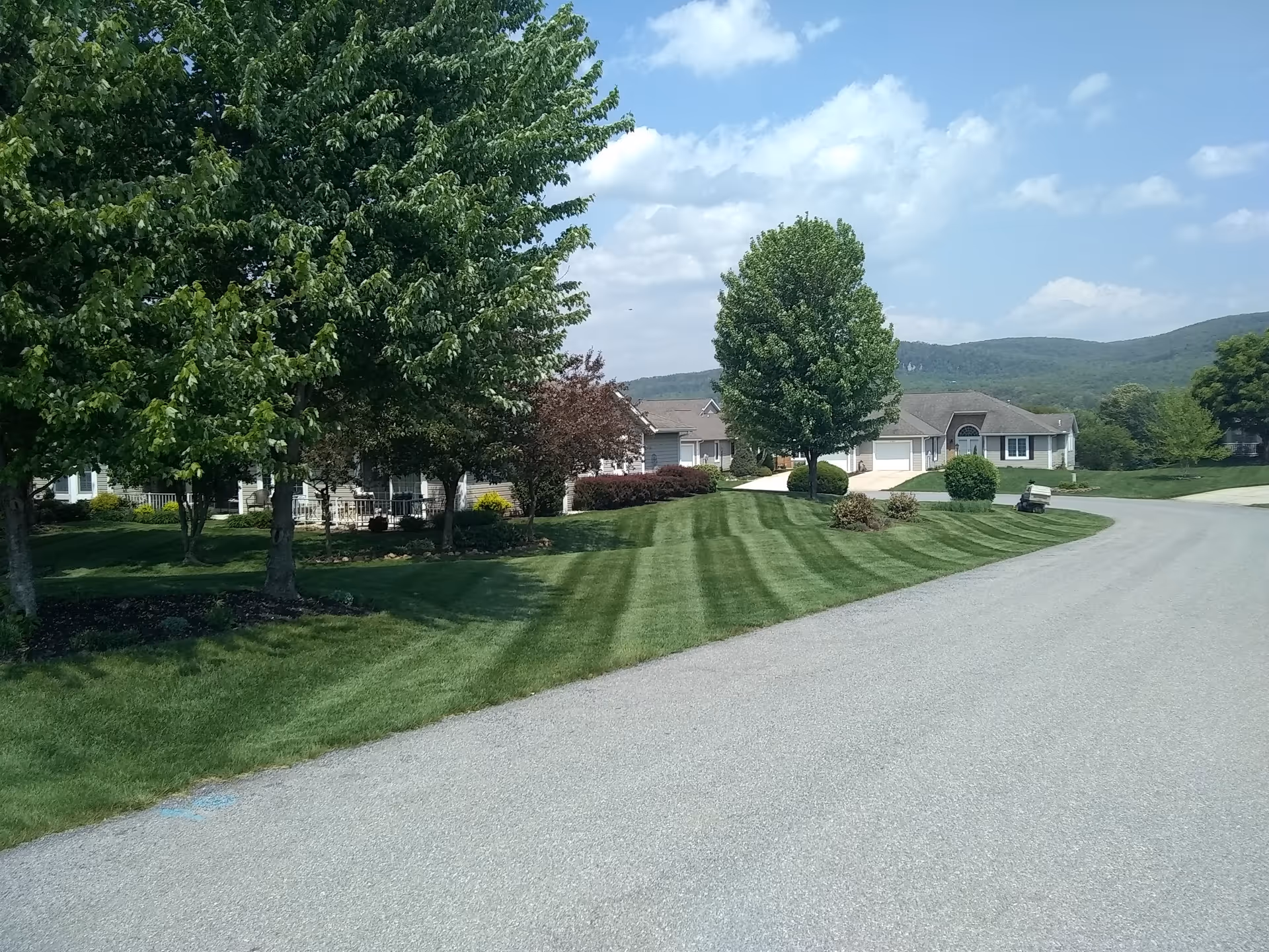 Exterior of Penn National senior living campus with manicured lawns and trees