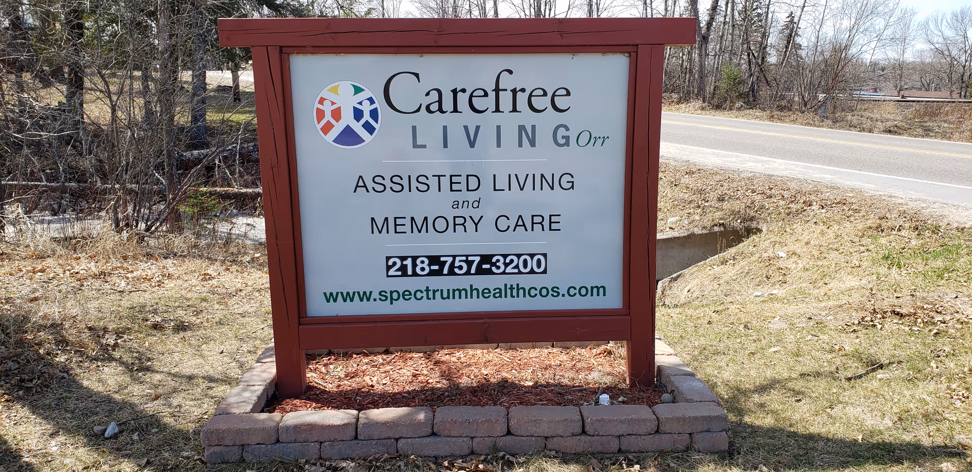 Outdoor sign for Carefree Living Orr assisted living near the road