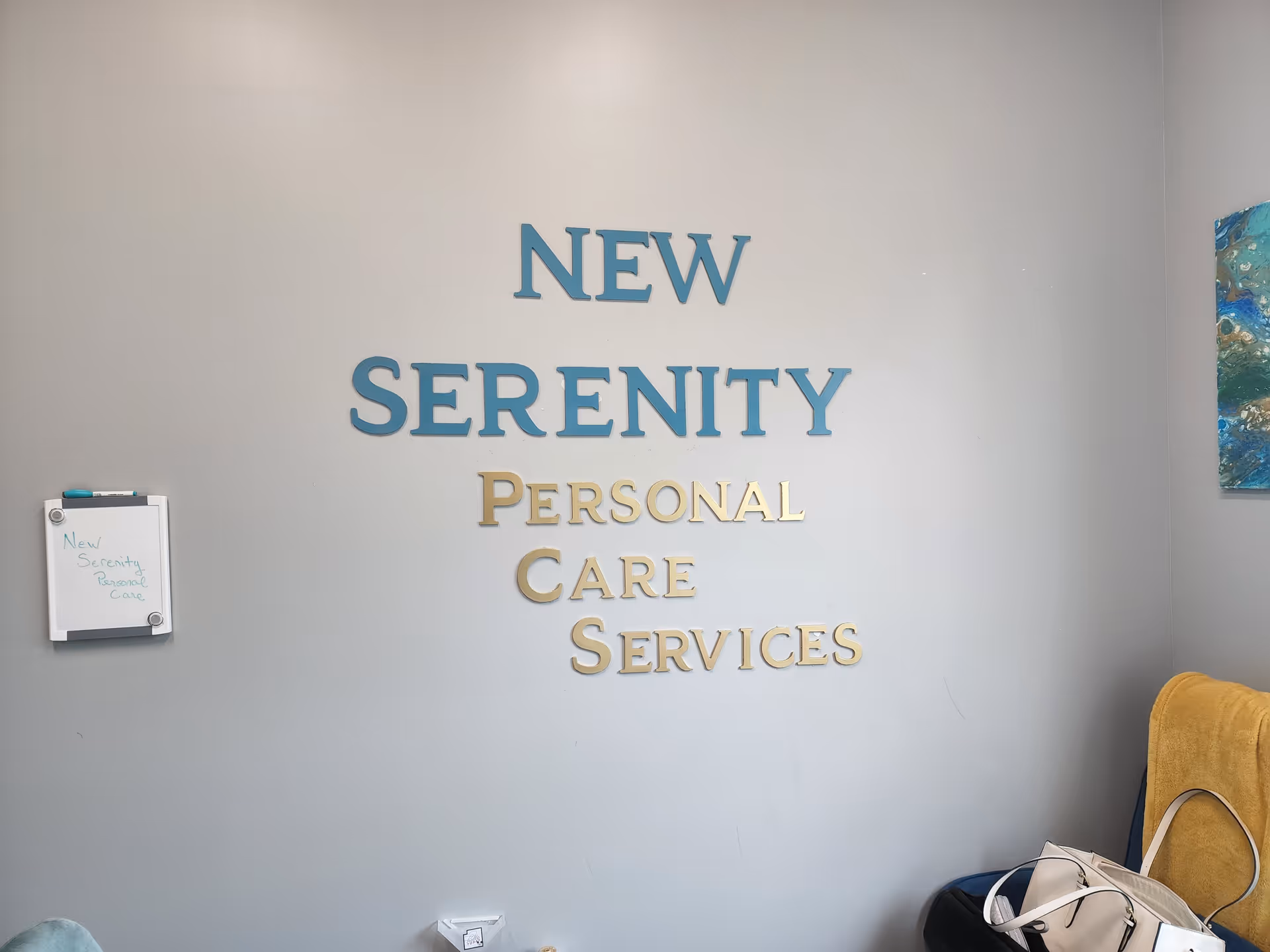 Interior wall with large blue sign reading New Serenity Personal Care Services