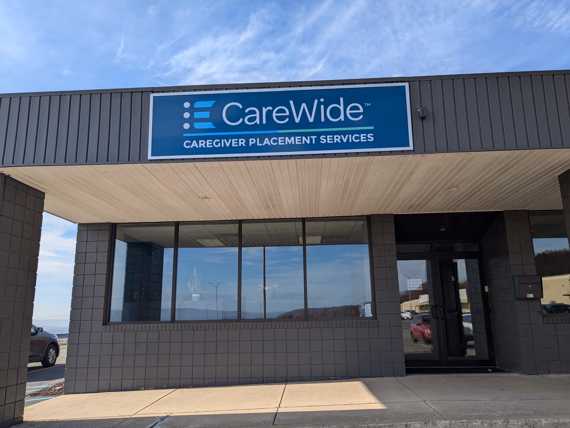 Exterior view of a CareWide building with a blue sign above the entrance.