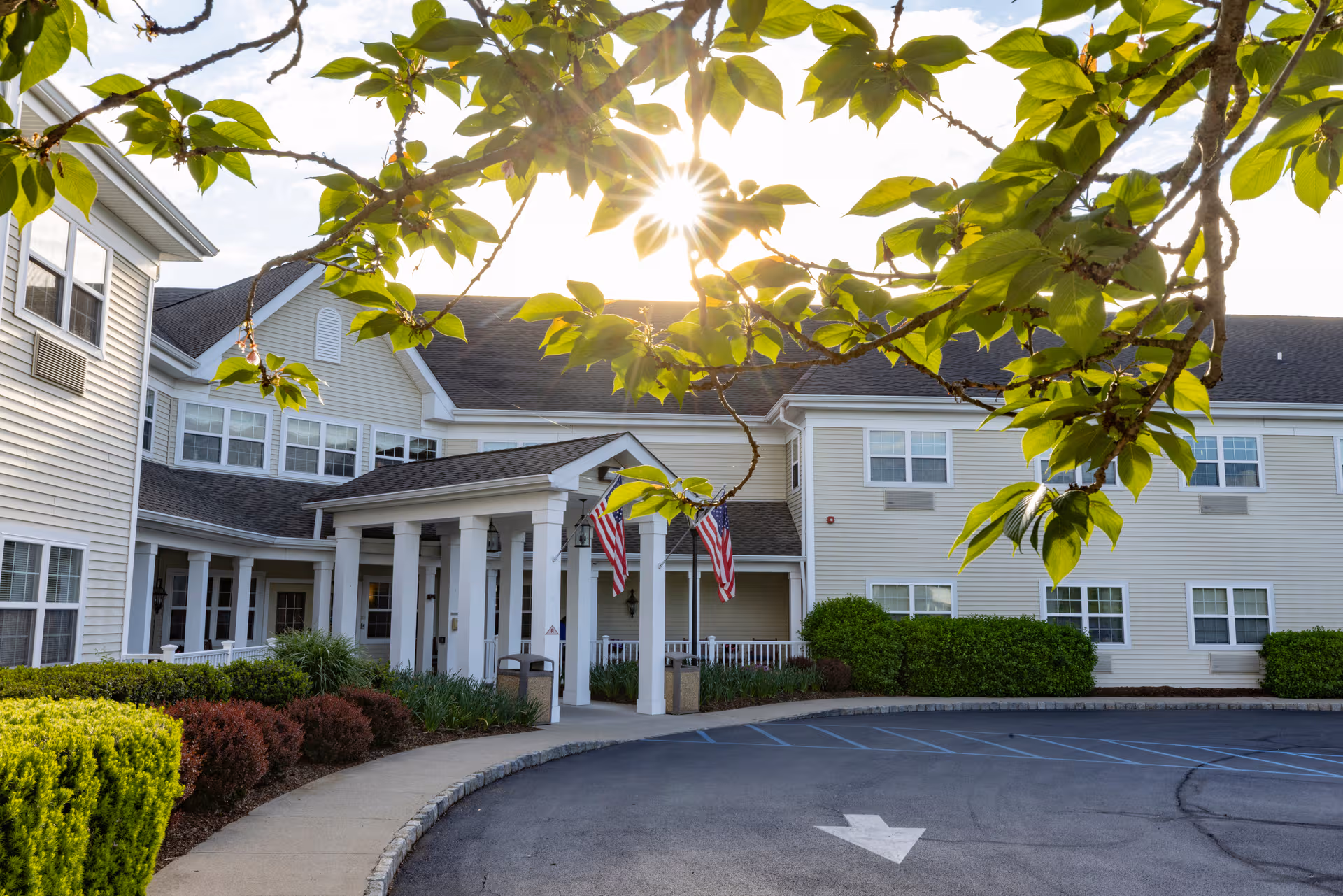 Exterior view of Mira Vie at Brookfield facility with entrance, parking lot, and landscaping.