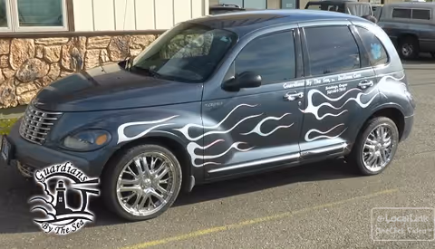 Gray SUV with white flame decals and Guardians by the Sea logo parked in lot