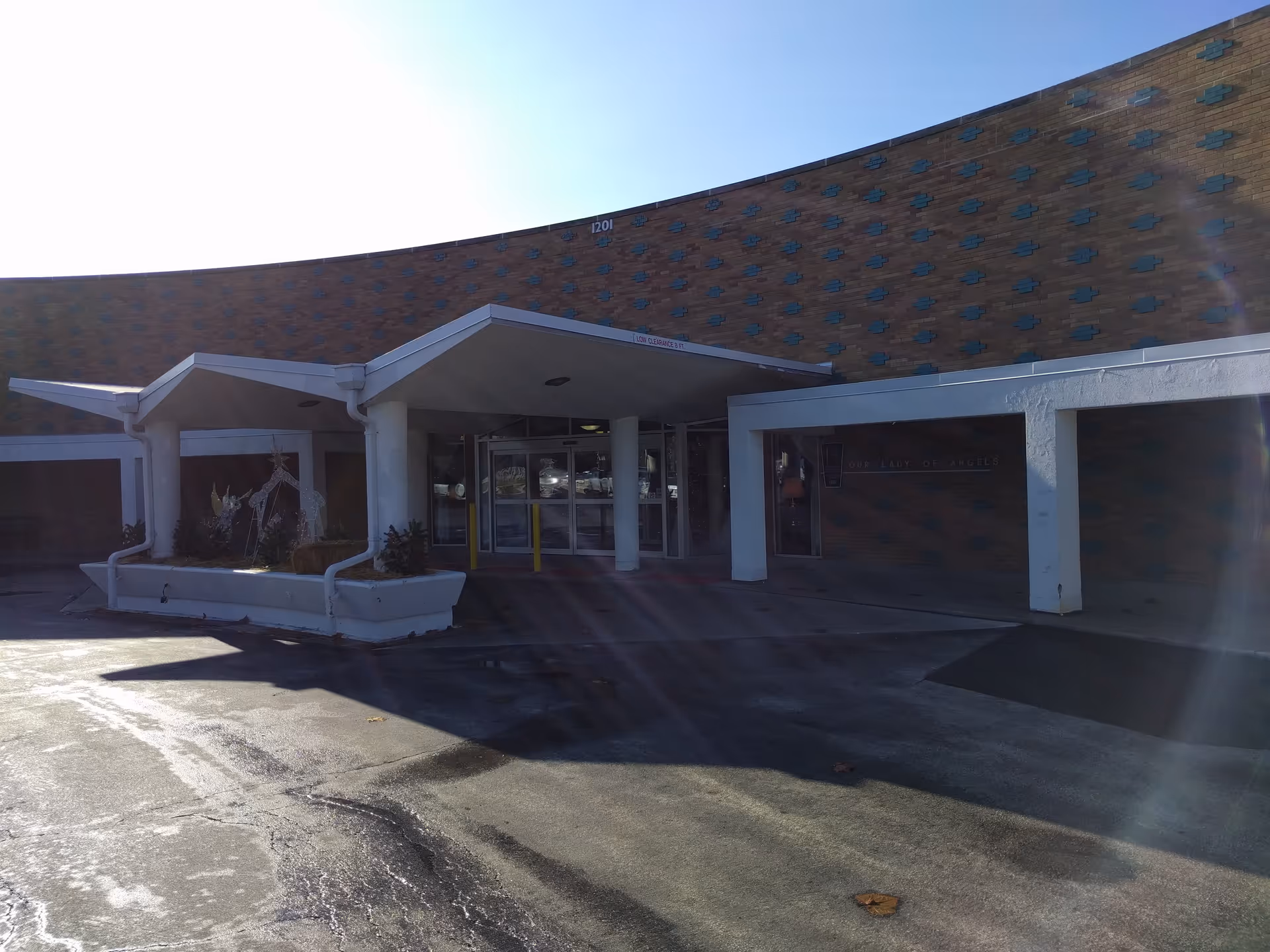 Wide view of Our Lady of Angels retirement home entrance with a covered drop-off.