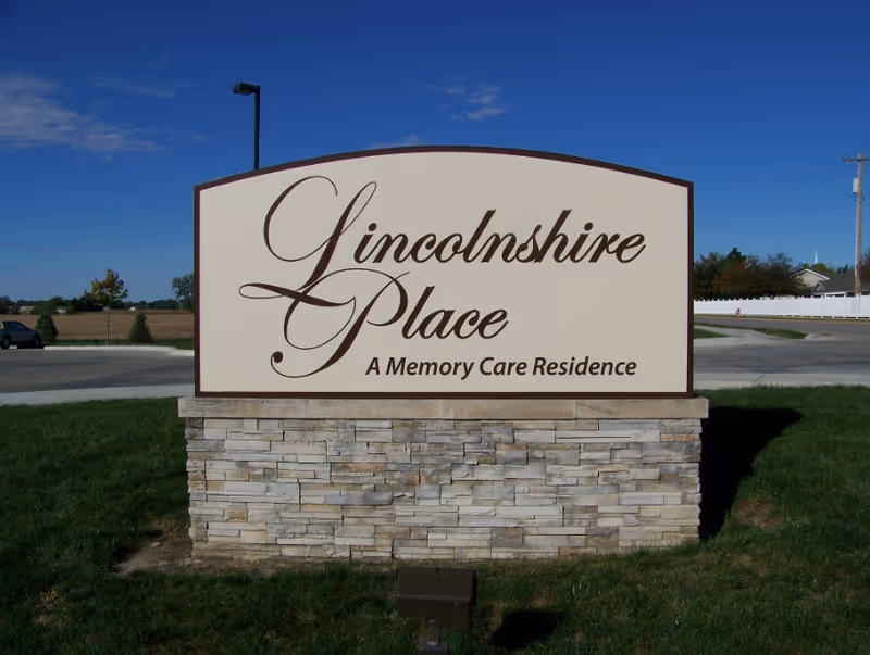 Exterior Lincolnshire Place sign with stone base on grass