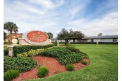 Well-manicured lawn, surrounding landscaping, and a sign for West Melbourne Health and Rehabilitation Center.