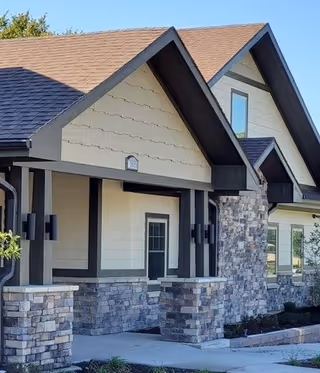 Front exterior view of The Cottages at Shawnee showing stone pillars and entrance porch.