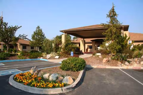 Exterior view of Life Care Center of Reno with entrance canopy and landscaped parking.