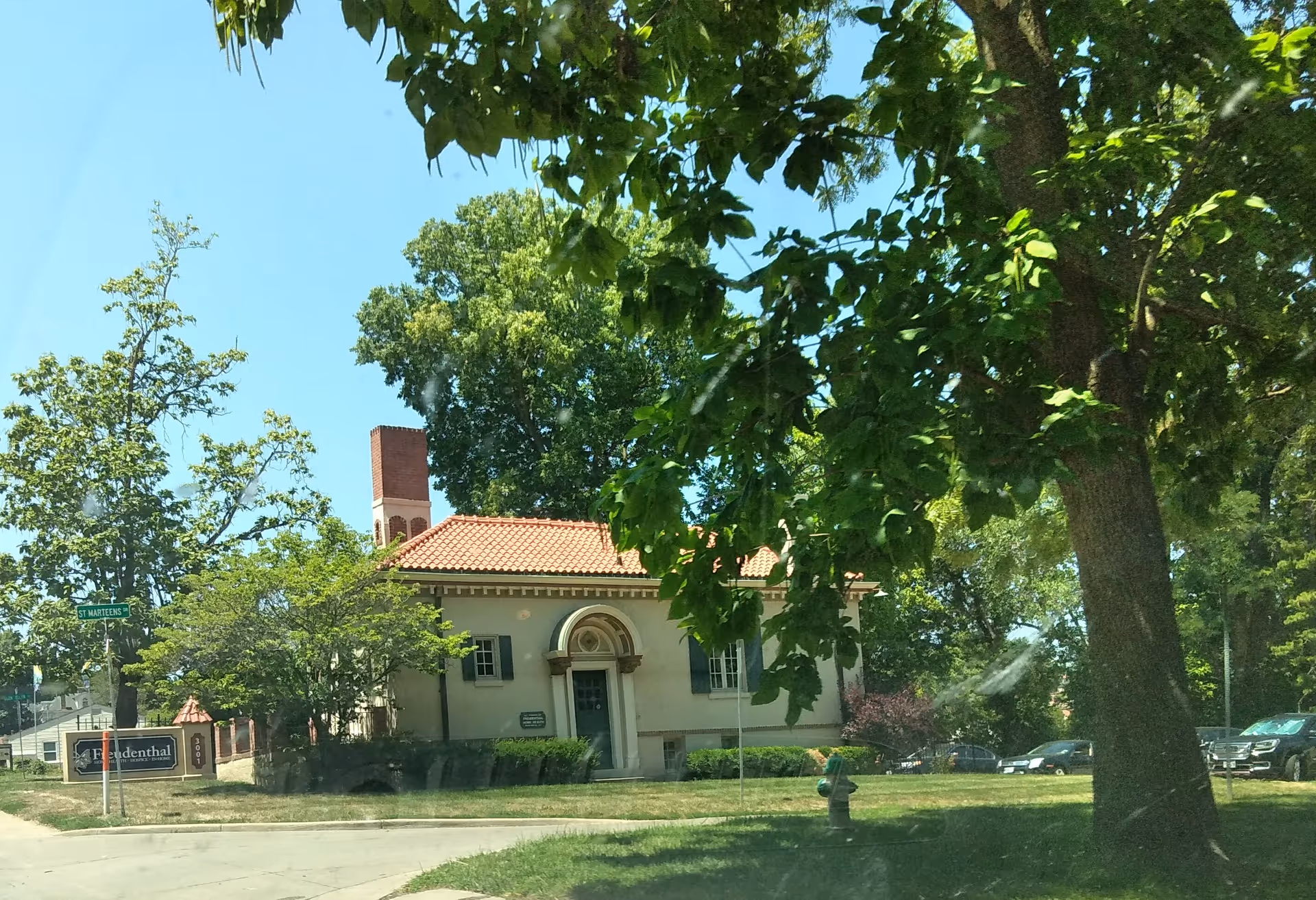 Exterior view of Freudenthal Home-Based Healthcare building with a red-tiled roof and trees.