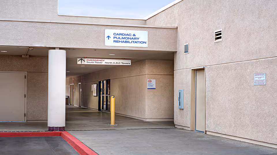Beige building exterior with a covered entrance and Cardiac and Pulmonary Rehabilitation sign.