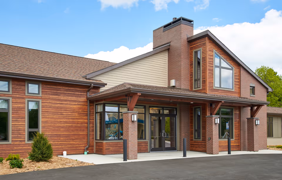 Front view of a modern brick-and-siding building with a glass entrance.