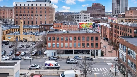 Downtown Springfield street view with brick buildings, cars, and a crosswalk.