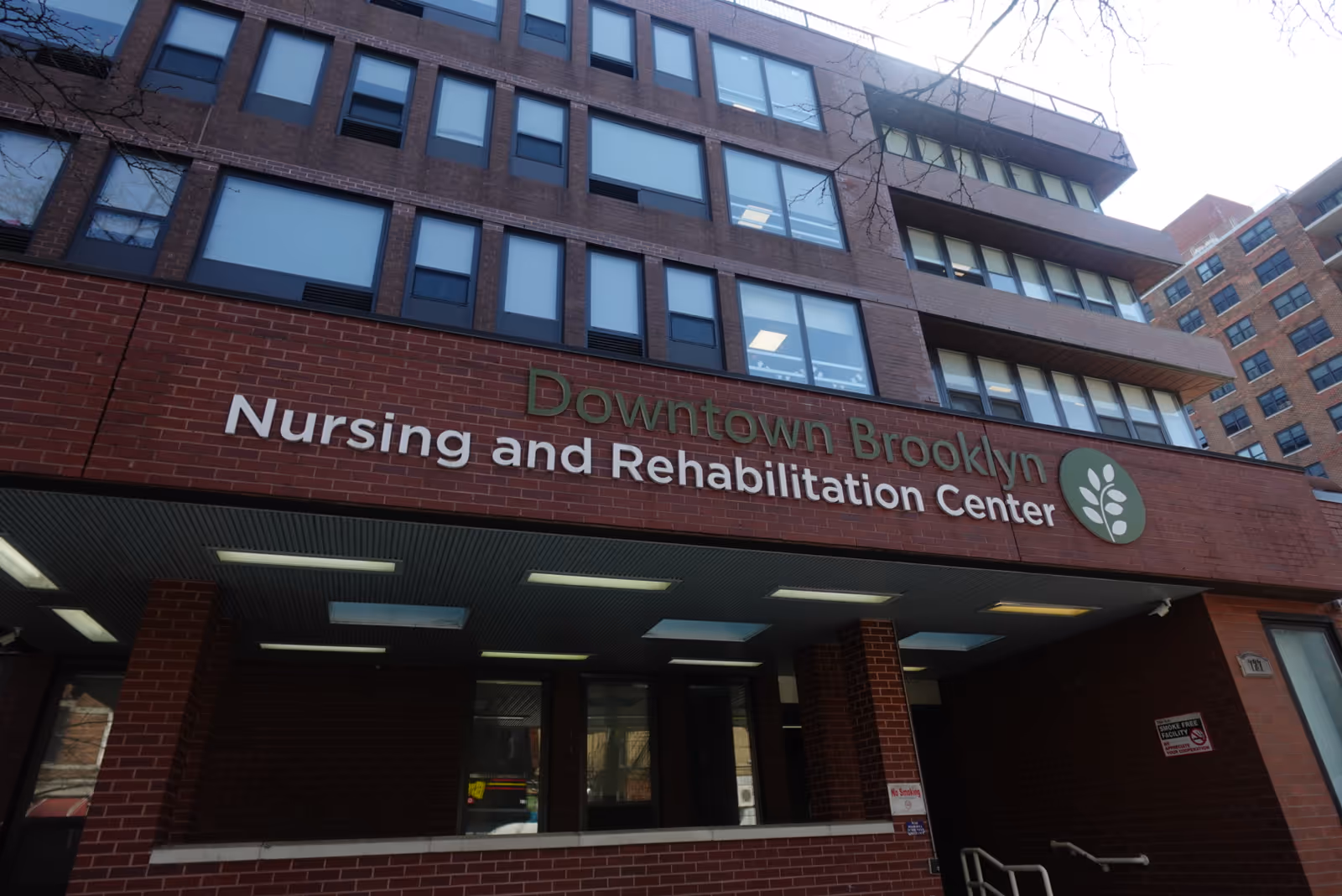 Brick building exterior with sign reading Downtown Brooklyn Nursing and Rehabilitation Center.