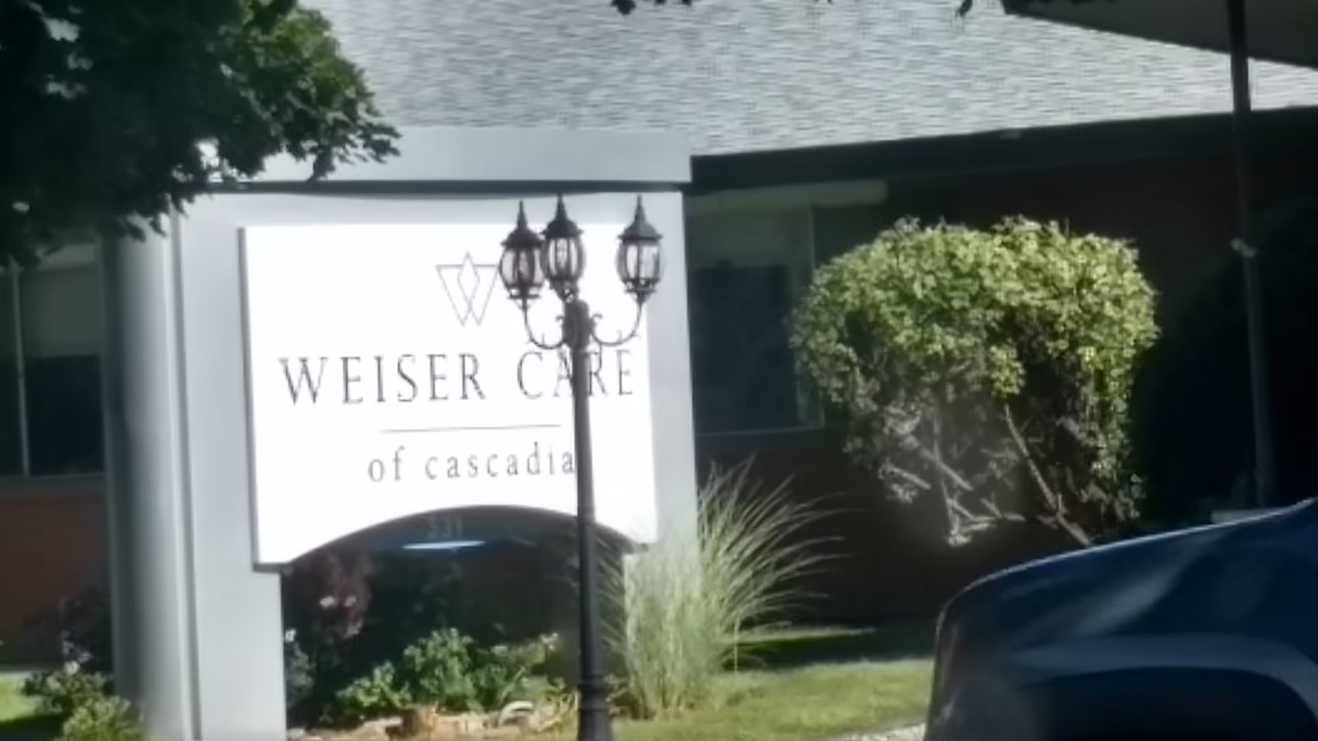 Front exterior of a building with a large sign reading Weiser Care of Cascadia.