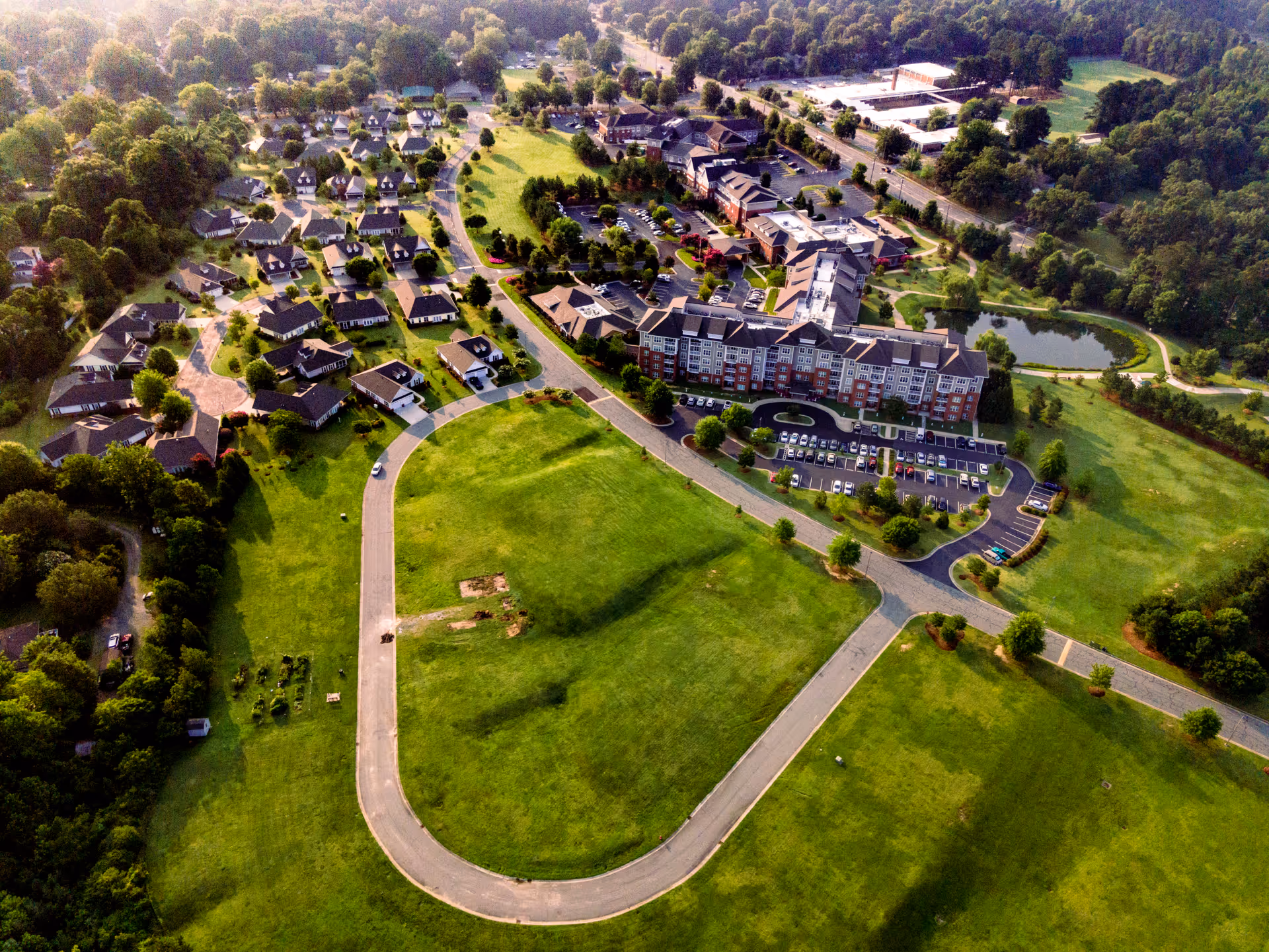 Aerial view of The Village at Brookwood campus with buildings, roads, and green grounds.