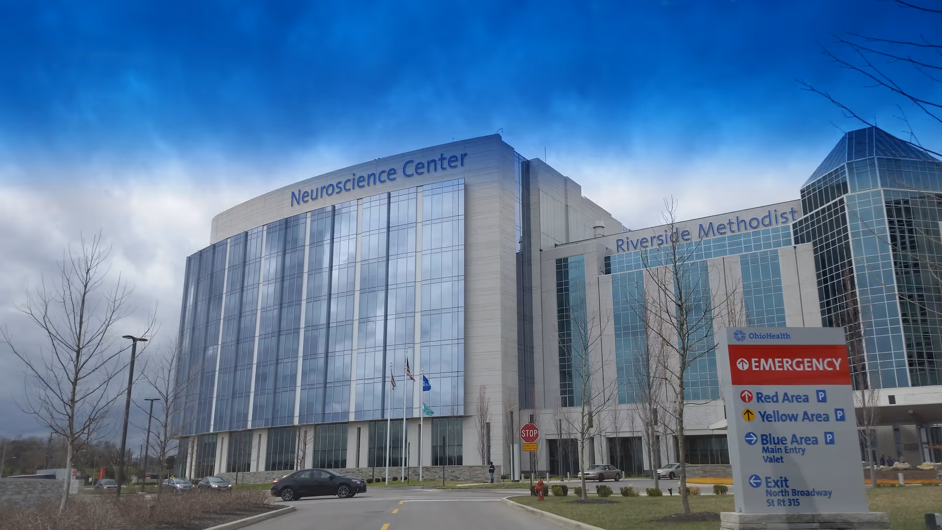 Exterior view of a large hospital building labeled Neuroscience Center and Riverside Methodist.